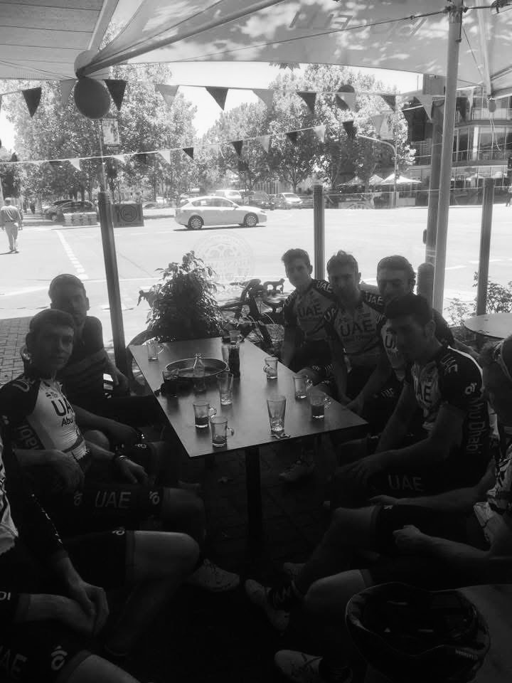 UAE Team Emirates riders sitting together at a café